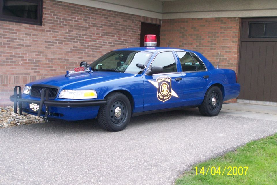 2003 Ford Crown Victoria Michigan State Police car parked in driveway