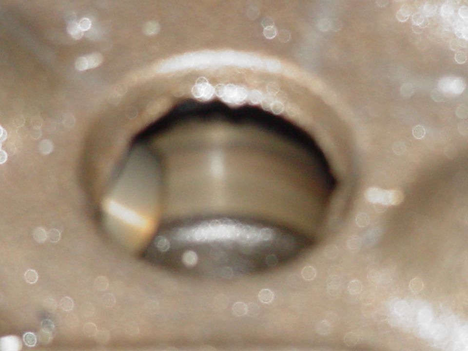 Close-up of a circular metal opening with blurred interior details