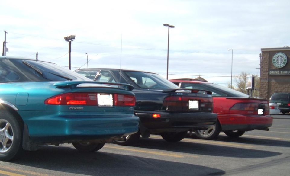 Teal 1989 Mazda MX-6 rear, black 1989 Mazda MX-6 rear, red 1989 Mazda MX-6 rear, Starbucks in background