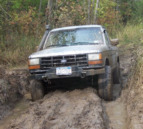 1978 Ford Bronco - This Ford Bronco is navigating a muddy trail with a snorkel and aftermarket bumper.