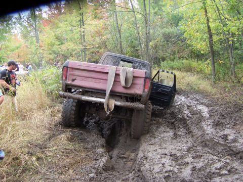 1978 Ford Bronco - This vehicle appears to be struggling to navigate a muddy, wooded path.