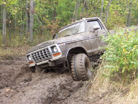 1978 Ford Bronco - This 1980s Ford Bronco navigates a challenging muddy terrain, its off-road capabilities.