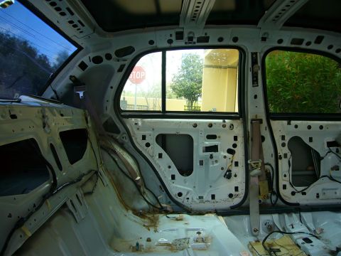 2001 Ford Crown Victoria - Interior of a car with door panels removed, revealing the internal structure.