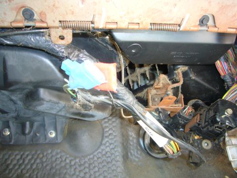 2001 Ford Crown Victoria - Close-up view of the interior wiring harness and electrical components, showing dust and connectors.