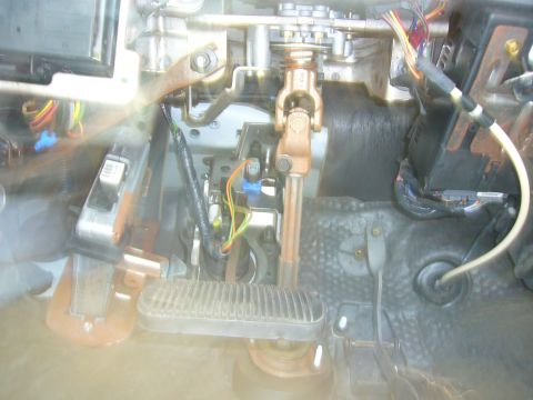 2001 Ford Crown Victoria - Interior view of steering column and pedals, showing mechanical and electrical components.