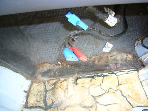 2001 Ford Crown Victoria - Close-up of car interior wiring harness connectors and a label, showing signs of wear and tear.