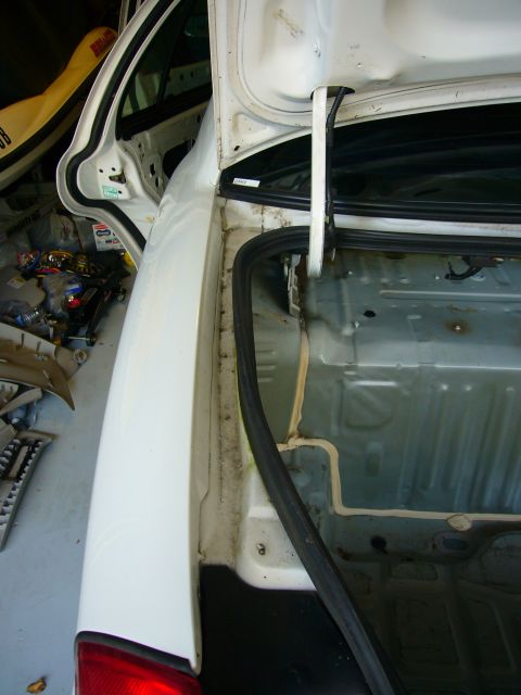 2001 Ford Crown Victoria - The interior of a car's trunk is exposed, revealing its internal structure and wiring.