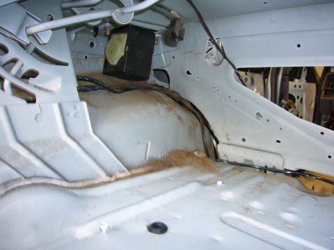 2001 Ford Crown Victoria - Bare metal interior of a car trunk, possibly undergoing restoration or cleaning.