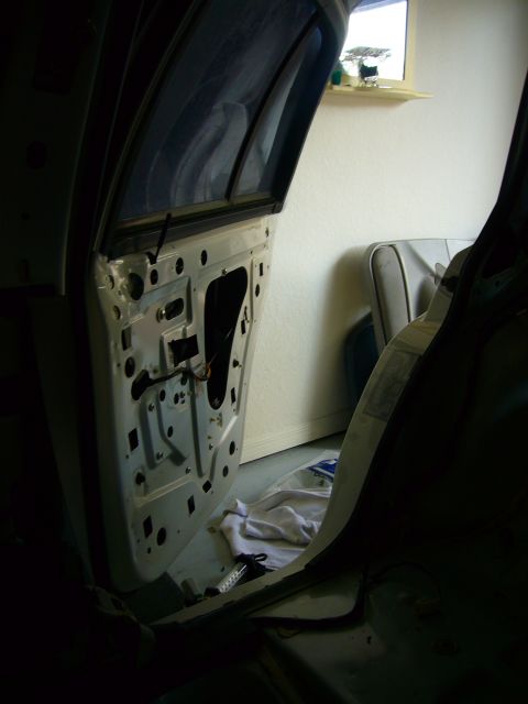 2001 Ford Crown Victoria - The interior of a 2001 Ford Crown Victoria shows the exposed door panel and wiring during a cleaning.