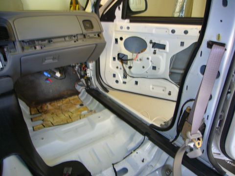 2001 Ford Crown Victoria - The interior of a 2001 Ford Crown Victoria is shown with its door panels and dashboard disassembled for work.