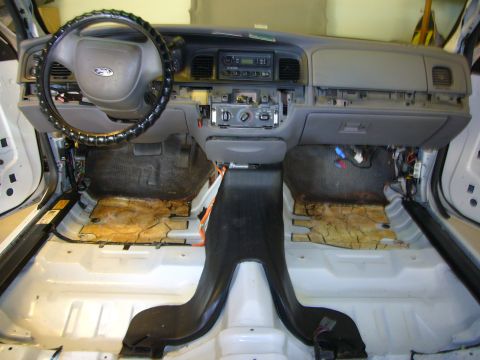 2001 Ford Crown Victoria - The interior of a 2001 Ford Crown Victoria is shown with the dashboard and seats disassembled.