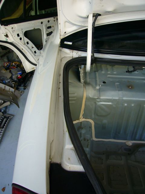 2001 Ford Crown Victoria - The interior of a car trunk is shown, revealing exposed wiring and insulation after cleaning.