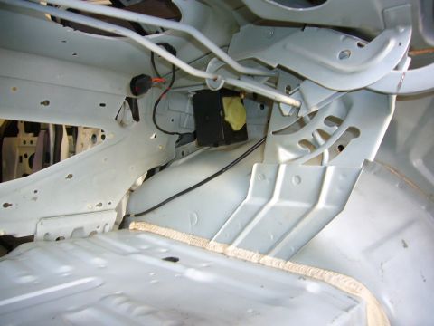 2001 Ford Crown Victoria - The interior structure of a vehicle is shown, with exposed metal and wiring, suggesting it is undergoing repair or restoration.