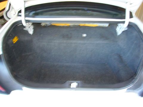 2001 Ford Crown Victoria - The interior of a car's trunk is shown with the lid open, revealing the cargo space.