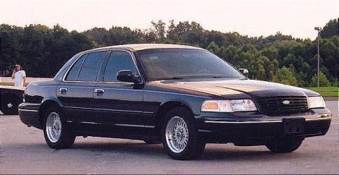 1999 Ford Crown Victoria - A black 1998 Ford Crown Victoria is shown from the front three-quarter angle.