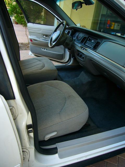 2001 Ford Crown Victoria - Interior view of a 2001 Ford Crown Victoria, highlighting the front seating area and dashboard.