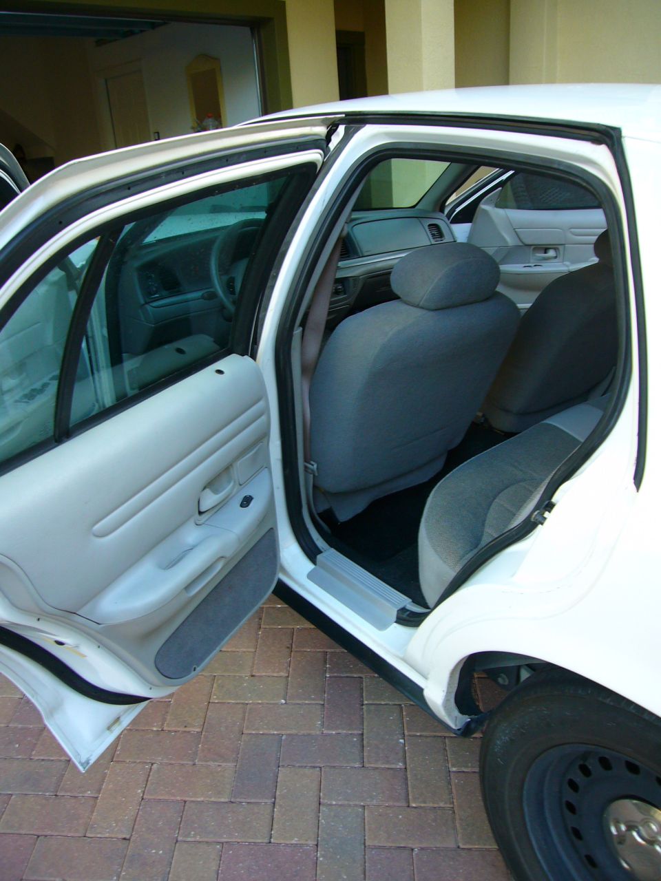 Interior of 2001 Ford Crown Victoria with front and rear doors open, showing grey cloth seats