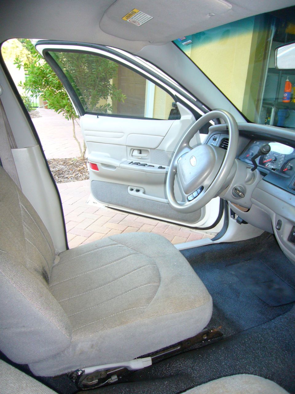 Interior of a 2001 Ford Crown Victoria, showing the driver's seat, dashboard, and steering wheel