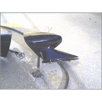 1973 Ford Ranchero - Two black car fender trim pieces are shown on a concrete surface.