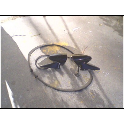 1973 Ford Ranchero - A pair of black side mirrors are shown on a concrete surface, possibly for sale or repair.