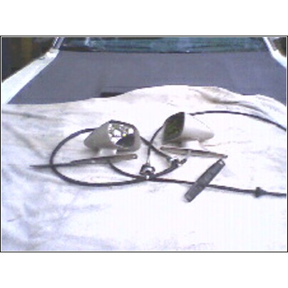 1973 Ford Ranchero - Car side mirrors and wiring are displayed on a white cloth, likely for repair or replacement.