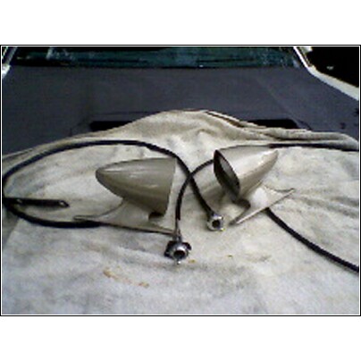1973 Ford Ranchero - A pair of vintage side mirrors are laid out on a cloth, possibly for installation or sale.