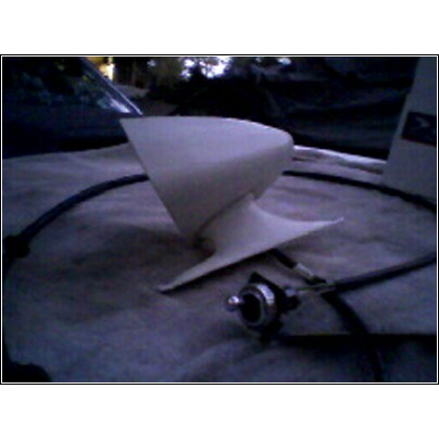 1973 Ford Ranchero - A white car part with a metal connector and black cable is laid out on a cloth surface.