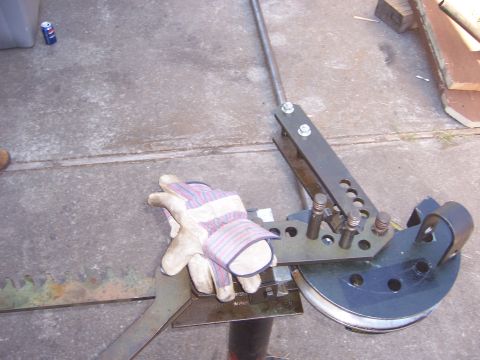 1991 Ford Bronco - A metal bending tool is shown with work gloves resting on it.