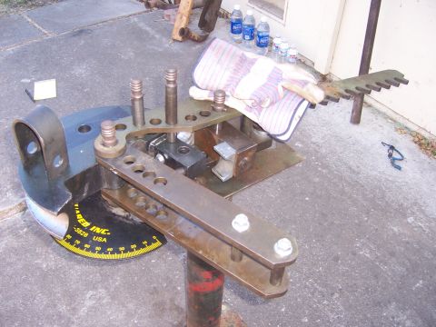 1991 Ford Bronco - A metal bending machine is shown with a protractor base and various metal components.