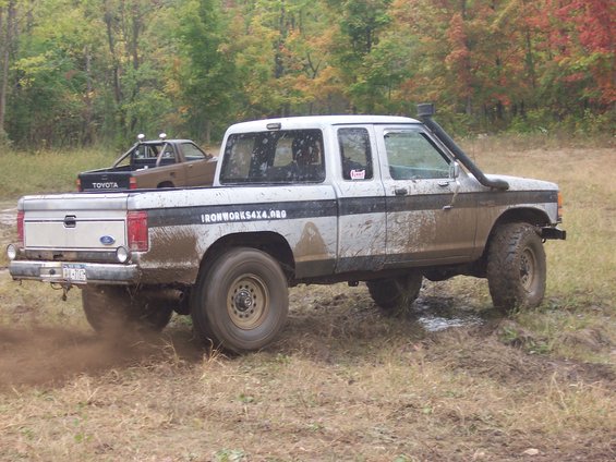 Muddy Ford Ranger with snorkel, another Toyota truck behind it