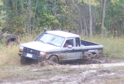 1990 Ford Ranger - A silver 1990 Ford Ranger navigates through a muddy off-road course.
