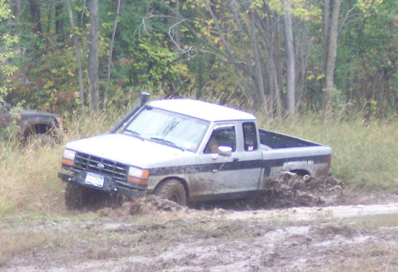 Silver 1990 Ford Ranger stuck in mud with snorkel