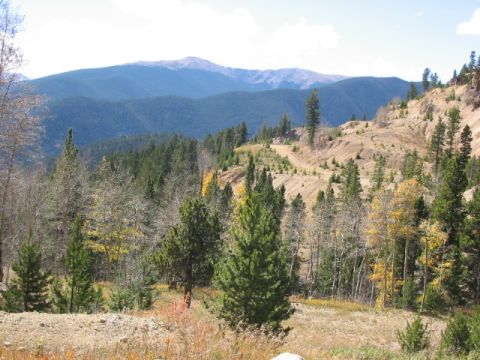 1995 Ford Bronco - A scenic view of a mountain landscape in Colorado during autumn, with rolling hills and a clear sky.