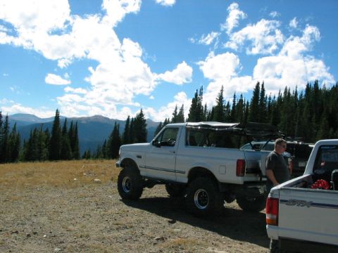 1995 Ford Bronco - Modified 1995 Ford Bronco parked in a scenic mountain landscape.