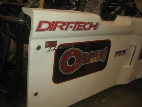 1990 Ford Bronco - close-up of a white off-road race body panel shows red Dirt-Tech lettering and a Rod End Supply sponsor decal.