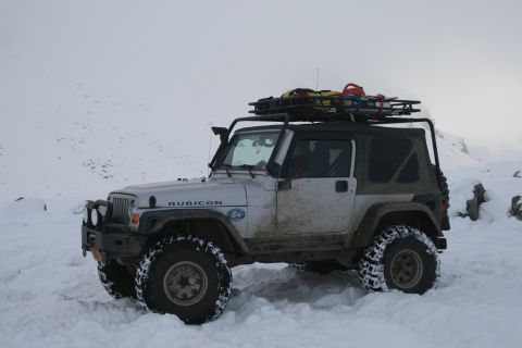 2003 Jeep TJ - Silver 2003 Jeep TJ Rubicon parked in snow with a roof rack loaded with gear.