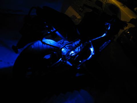 2007 Kawasaki Ninja - A motorcycle is illuminated by blue LED lights, with only parts of its frame and rear tire visible in the dark.