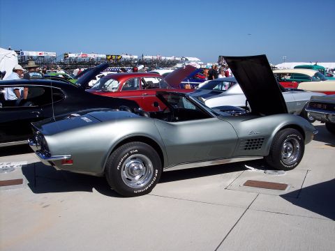 1971 Ford Mustang - A silver 1970 Corvette convertible is displayed with its hood open among other vehicles.