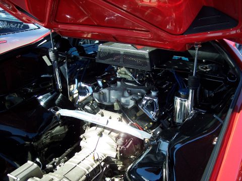 1971 Ford Mustang - Engine bay of a red car, showing the V8 engine and various components.