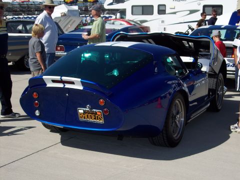 1971 Ford Mustang - A blue coupe with white racing stripes is displayed with its doors open, a custom license plate.