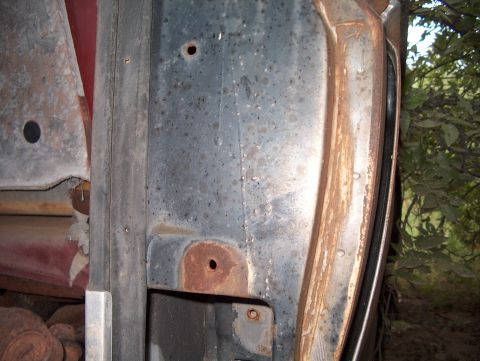 1979 Ford Bronco - Close-up view of a heavily rusted door frame, showing signs of significant wear and tear.