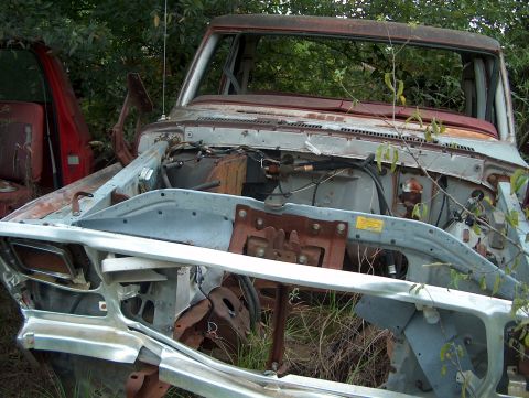 1979 Ford Bronco - This 1979 Ford Bronco is heavily rusted and appears to be in a junkyard setting.