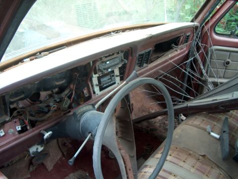1979 Ford Bronco - The interior of this vehicle is in disrepair, with exposed wires and debris.