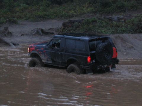1989 Ford Bronco - 1989 Ford Bronco navigating a water crossing off-road.