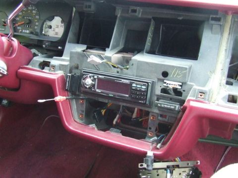 1992 Ford Crown Victoria - Interior view of a 1992 Ford Crown Victoria dashboard, with the radio assembly disassembled.