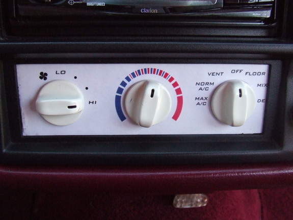 Climate control knobs with labels for fan speed, temperature, and air direction