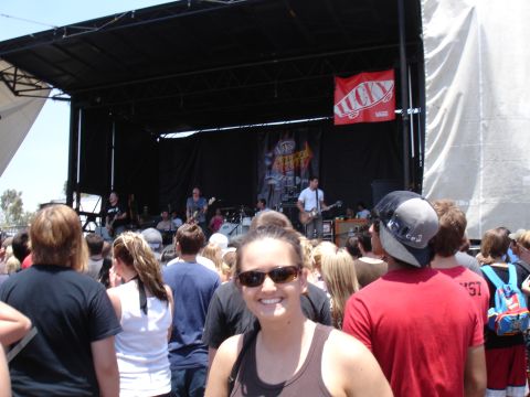 1992 Ford F-150 - A band plays on a stage at an outdoor event, with a crowd gathered in front.