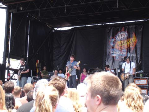 1992 Ford F-150 - A band plays on stage at the Vans Warped Tour 07 event, with a crowd watching.
