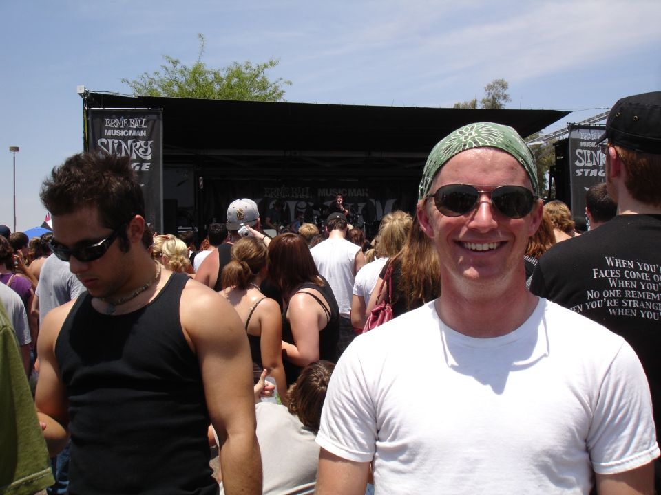 Outdoor concert crowd with a stage in the background