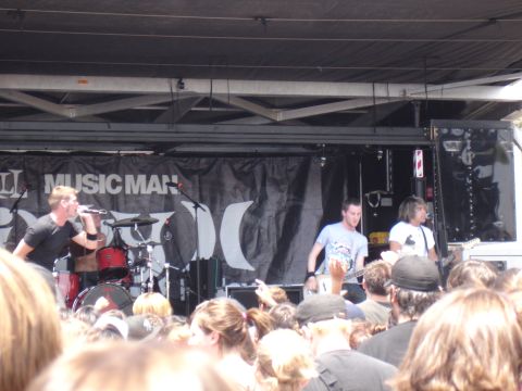 1992 Ford F-150 - A band plays on stage in front of a large crowd, with a "MUSIC MAN" banner visible.
